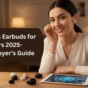 A smiling woman with dark hair wears a white wireless earbud in one ear and gently touches it. On the wooden table in front of her, several different colored wireless earbuds are scattered around a tablet displaying a futuristic interface. The blog title "Best Wireless Earbuds for Small Ears 2025 - Reviews & Buyer's Guide" is overlaid on the image.